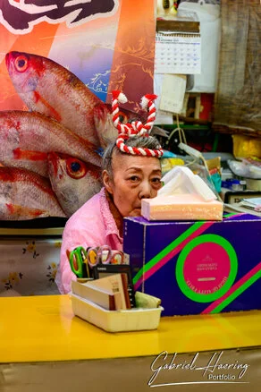 Crowded Ōmichō Market in Kanazawa during lunchtime with food stalls and visitors