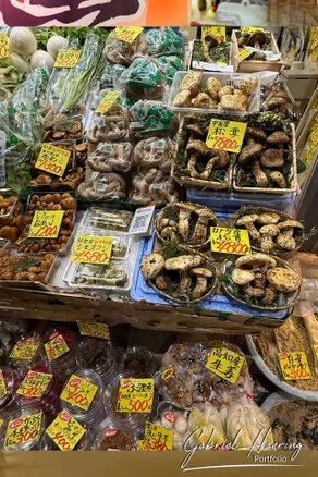 Crowded Ōmichō Market in Kanazawa during lunchtime with food stalls and visitors